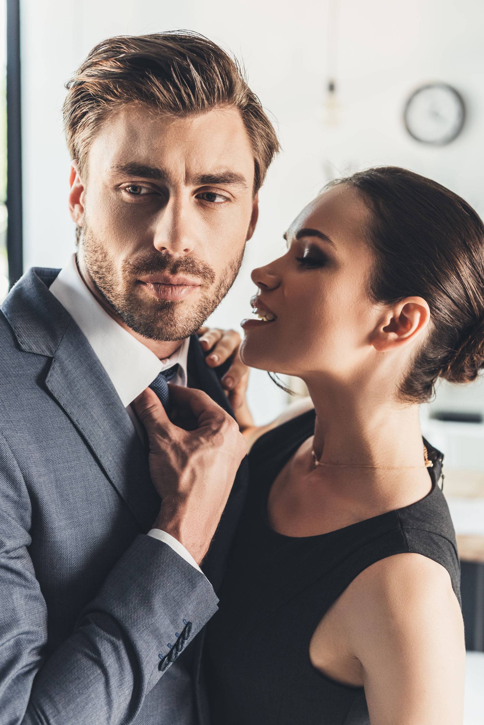 woman trying to kiss man in suit