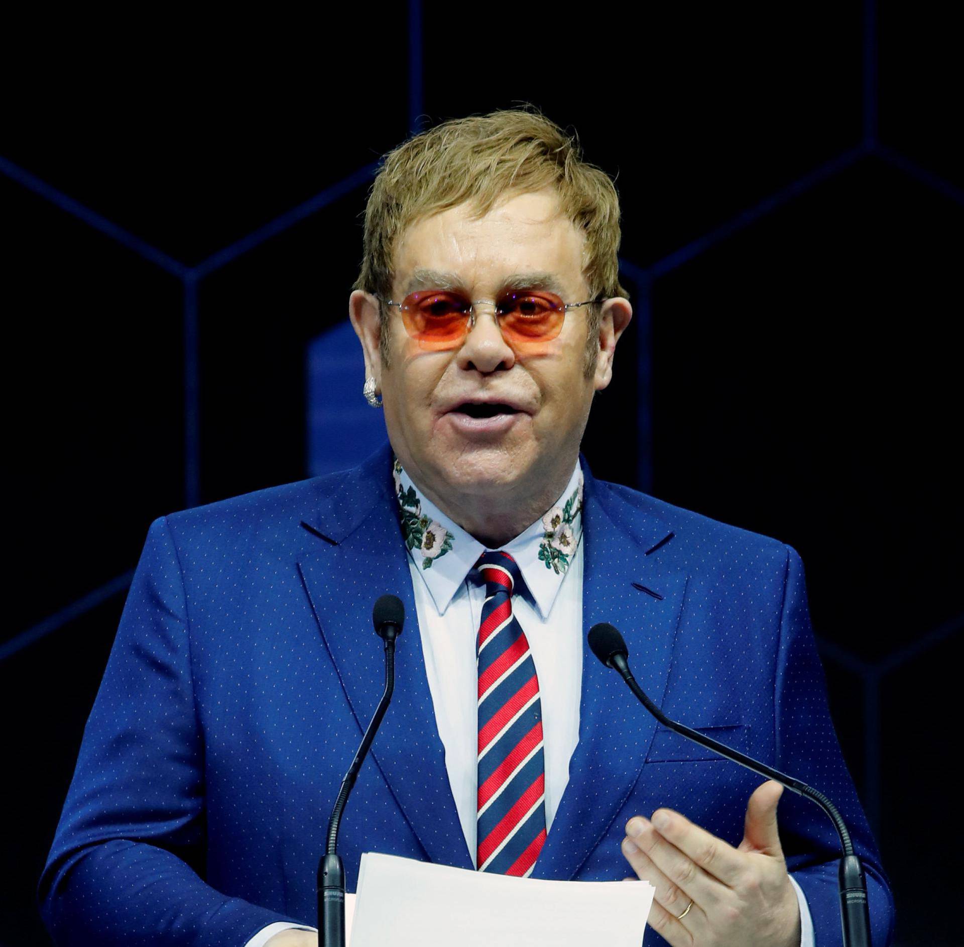 Singer Elton John speaks after receiving a Crystal Award from Hilde Schwab, Chairperson and Co-Founder, Schwab Foundation for Social Entrepreneurship, during the World Economic Forum (WEF) annual meeting in Davos