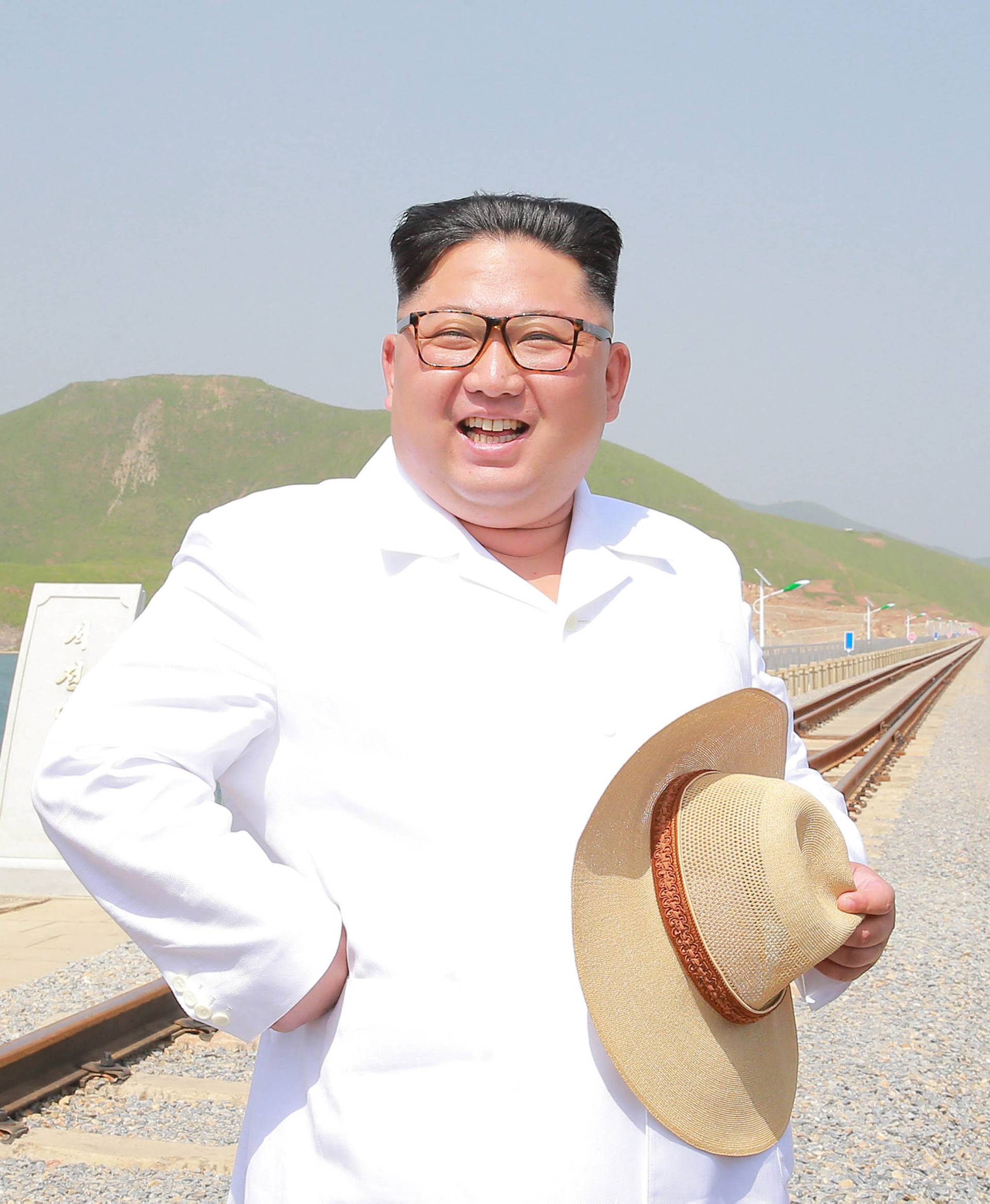 North Korean leader Kim Jong Un inspects the completed railway that connects Koam and Dapchon, in this undated photo released by North Korea's Korean Central News Agency