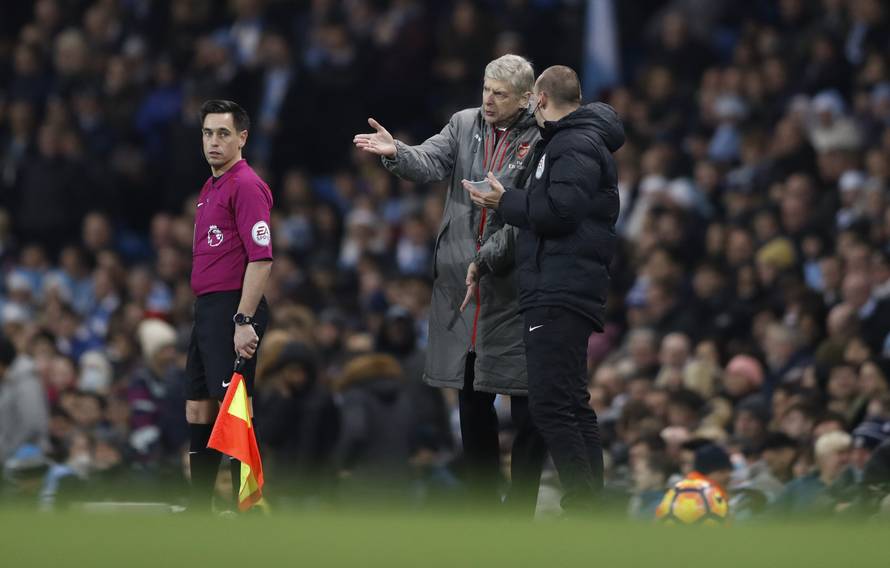 Arsenal manager Arsene Wenger talks to fourth official Robert Madley
