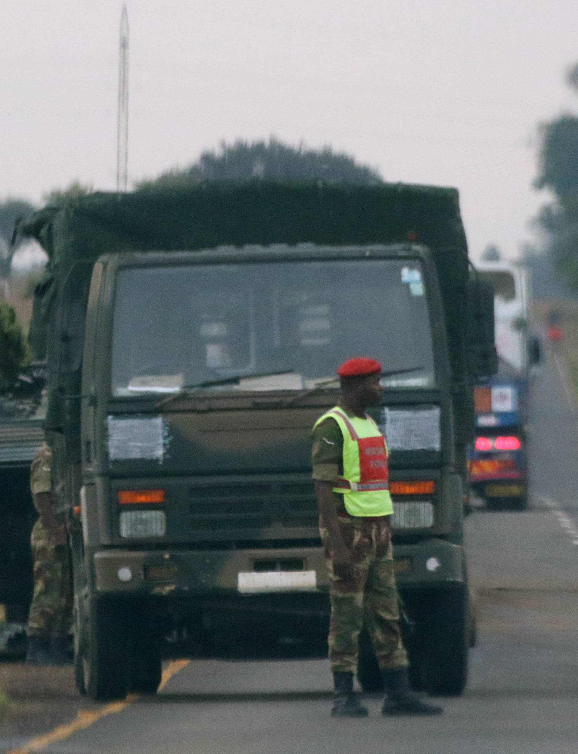 Soldiers stand beside military vehicles just outside Harare,Zimbabwe