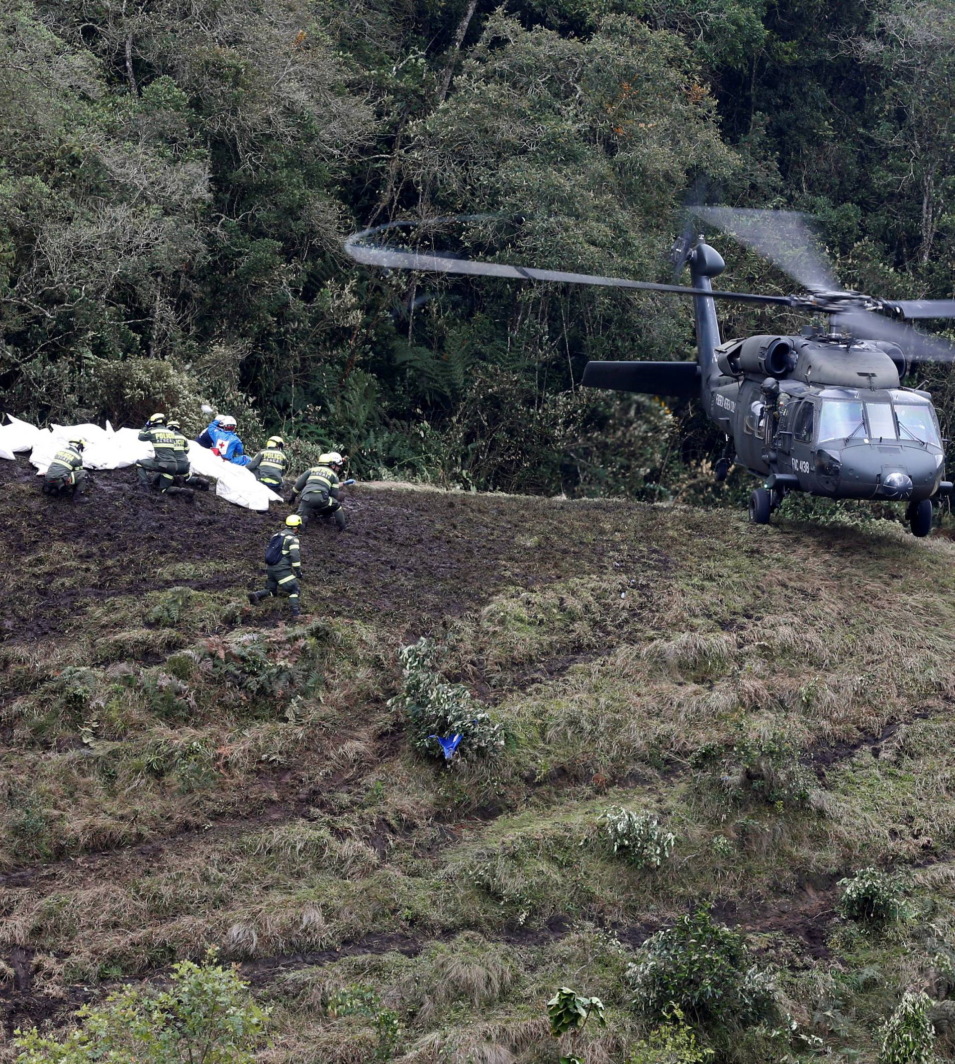 A Colombian air force helicopter arrives to retrieve the bodies of victims from the wreckage of a plane that crashed into the Colombian jungle with Brazilian soccer team Chapecoense onboard, near Medellin