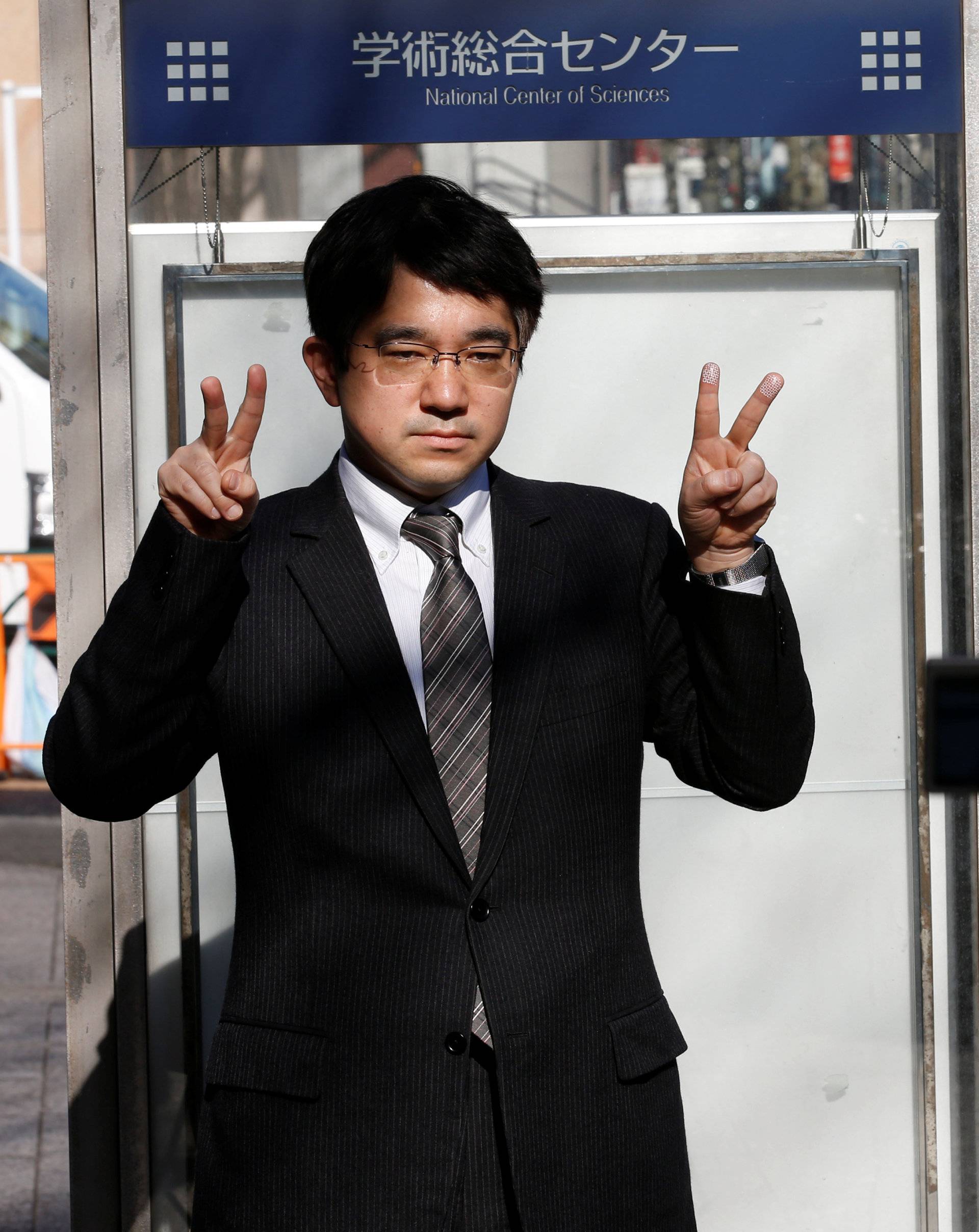 Echizen, a professor at Japan's National Institute of Informatics, gestures during a demonstration of his experiment for Reuters in Tokyo