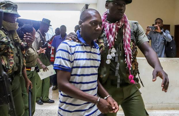 FILE PHOTO: Paul Mackenzie, a Kenyan cult leader accused of ordering his followers, who were members of the Good News International Church, to starve themselves to death in Shakahola forest, is escorted to the Malindi Law Courts