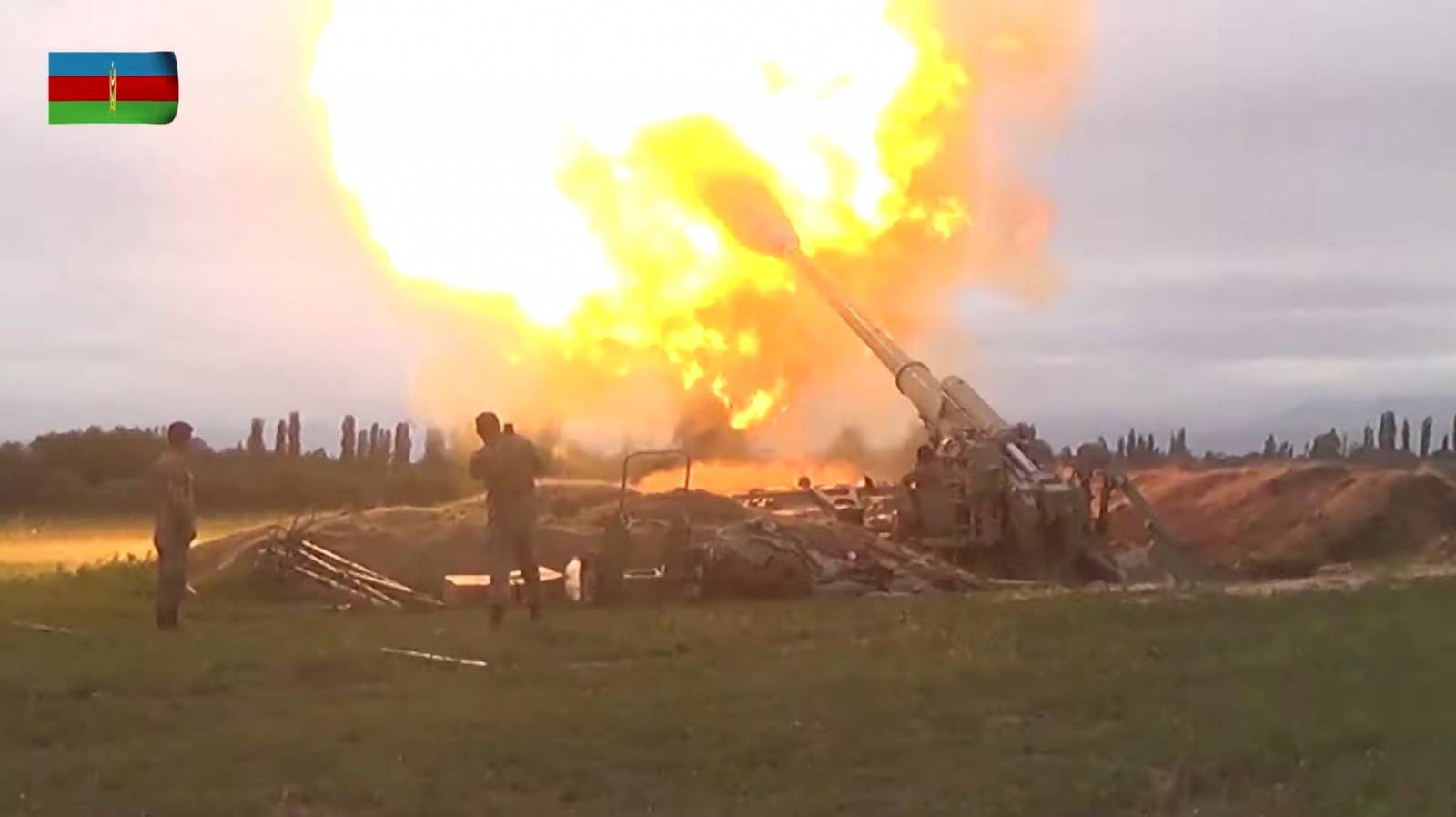 A still image shows members of Azeri armed forces firing artillery in an unidentified location