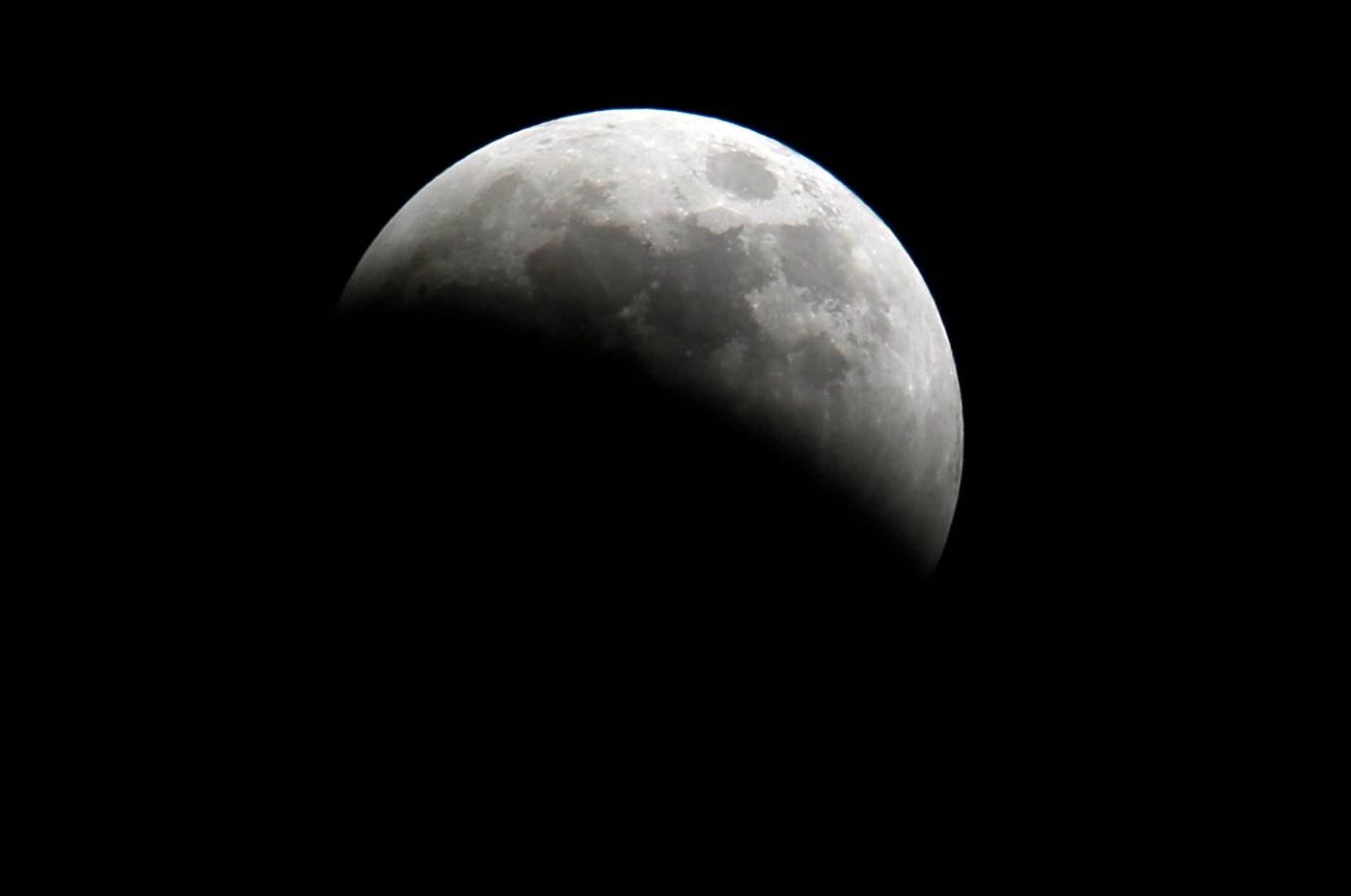 A lunar eclipse of a full "Blood Moon" rises near the Oloitoktok town along the Kenya-Tanzania border