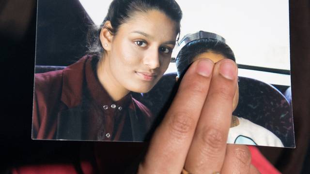 FILE PHOTO: Renu Begum, sister of teenage British girl Shamima Begum, holds a photo of her sister as she makes an appeal for her to return home at Scotland Yard, in London