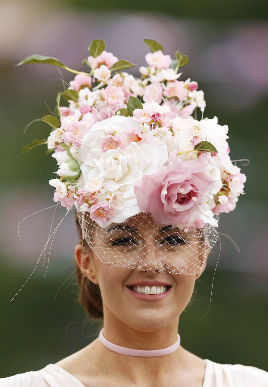 Britain Horse Racing Ladies Day Racegoer wears hat