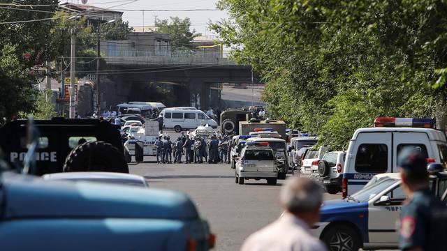 Policemen block a street after group of armed men seized a police station along with an unknown number of hostages, according the country's security service, in Yerevan, Armenia