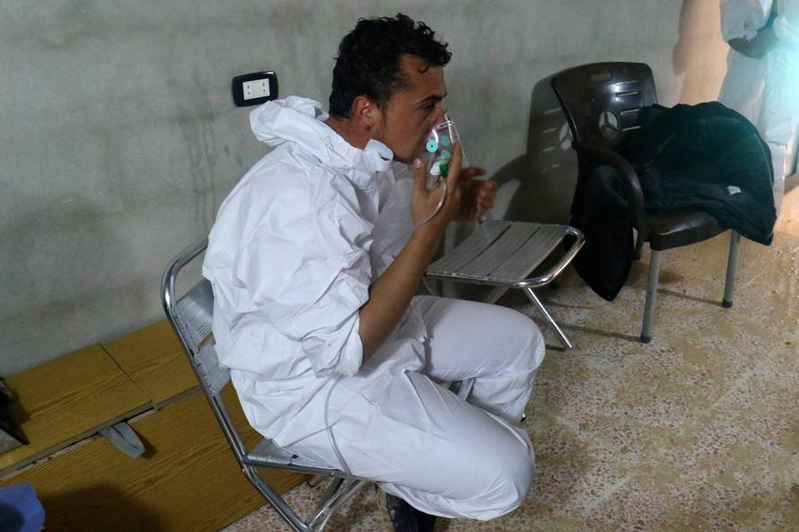 A man breathes through an oxygen mask, after what rescue workers described as a suspected gas attack in the town of Khan Sheikhoun in rebel-held Idlib