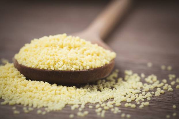 Cous cous on a wooden spoon