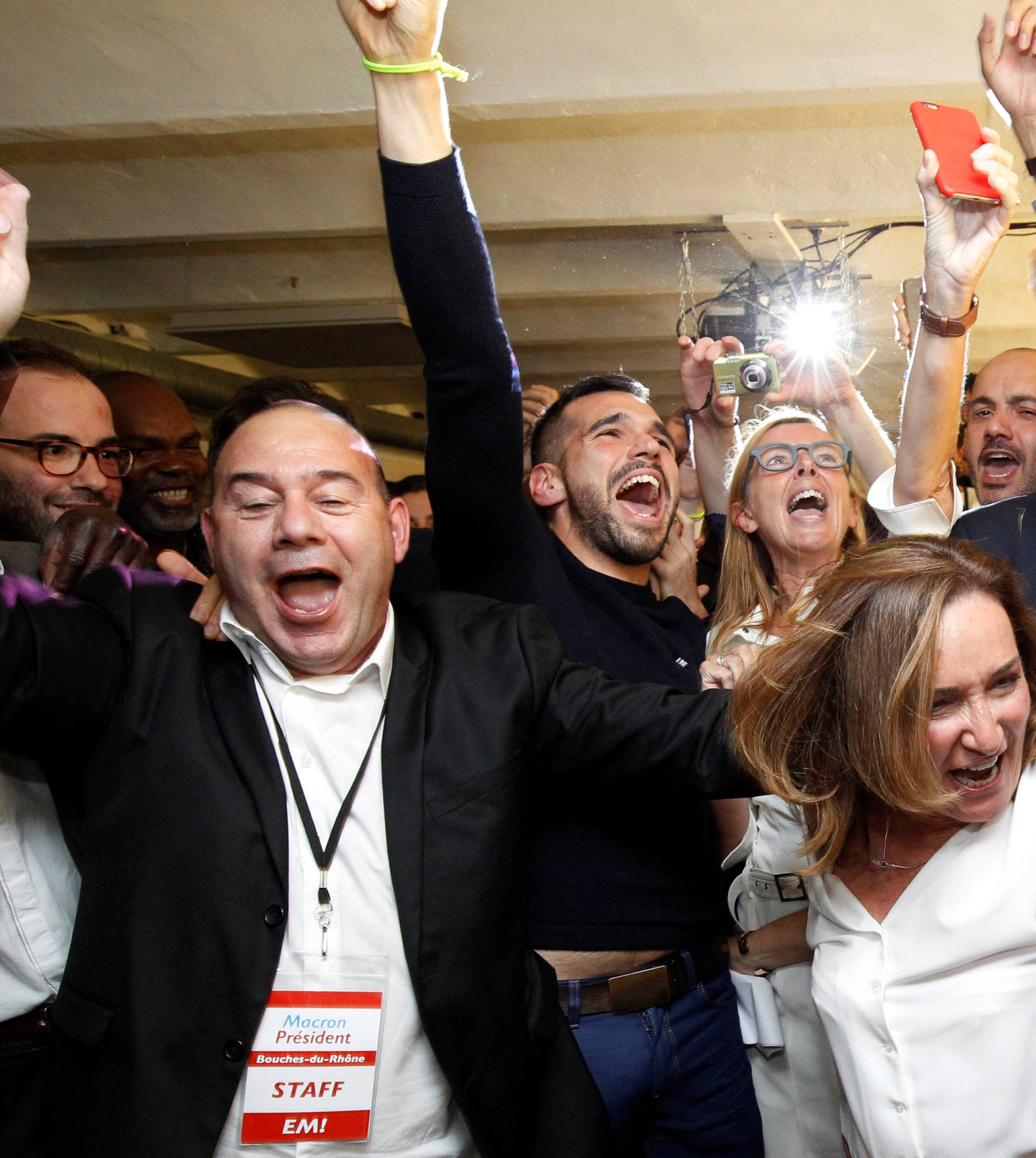 Supporters of French President-elect Emmanuel Macron, head of the political movement En Marche !, or Onwards !, react after announcement in the second round of 2017 French presidential election at En Marche local headquarters in Marseille