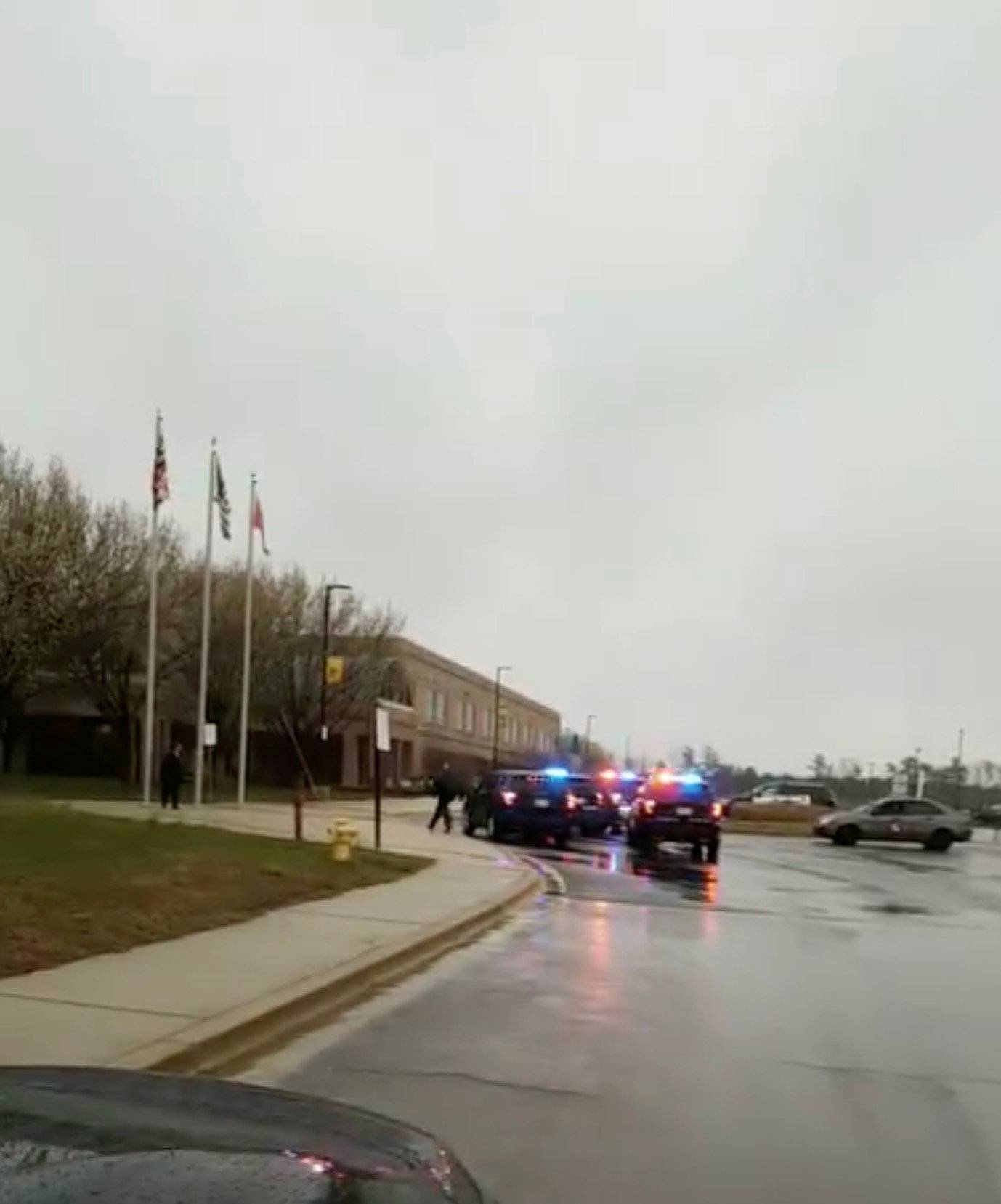 Law enforcement vehicles arrive at the Great Mills High School in Lexington Park