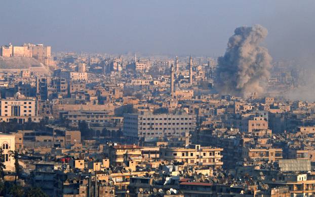 Smoke rises as seen from a government-held area of Aleppo