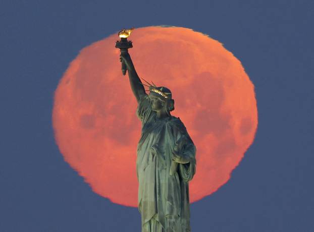 Pink Supermoon Over the Statue Of Liberty in New York