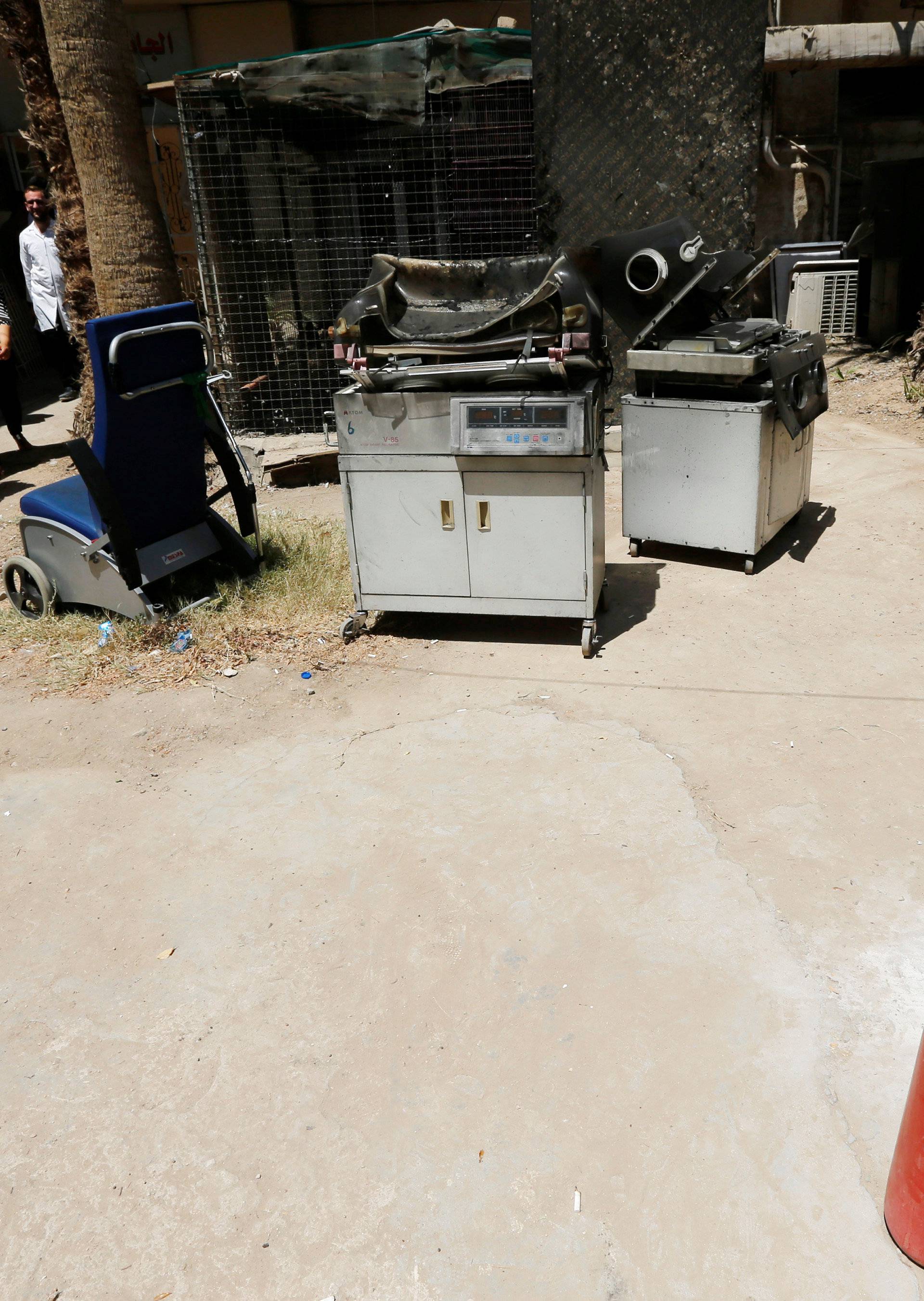 Burnt incubators stand outside a maternity ward after a fire broke out at Yarmouk hospital in Baghdad