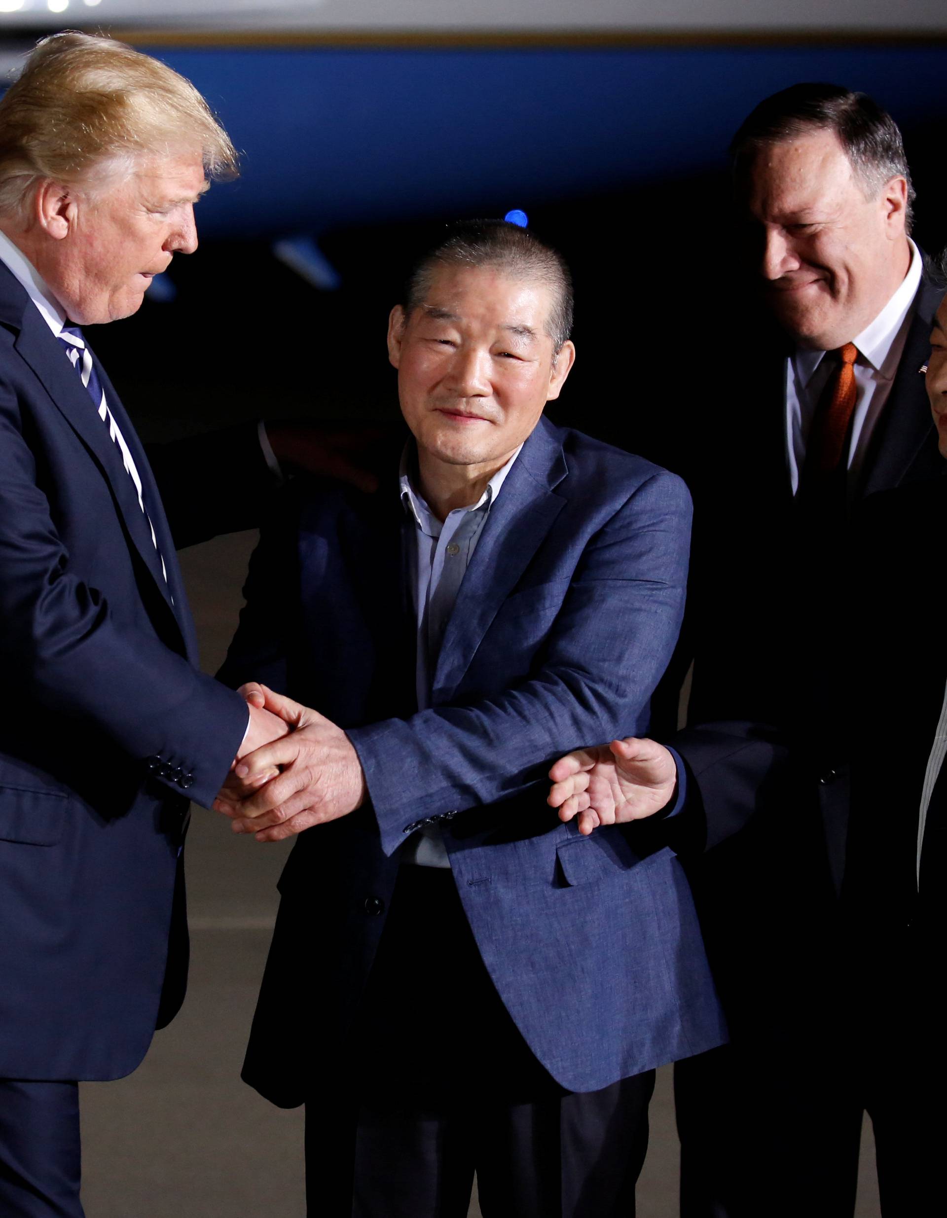U.S.President Donald Trump greets the Americans formerly held hostage in North Korea upon their arrival at Joint Base Andrews