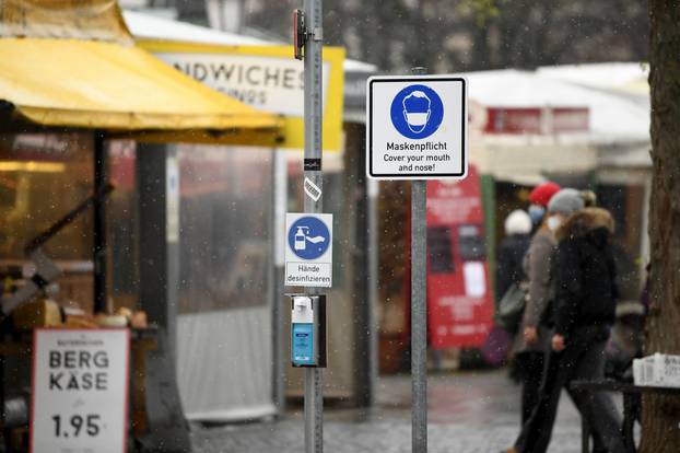 People walk across Viktualienmarkt as the spread of the coronavirus disease (COVID-19) continues in Munich