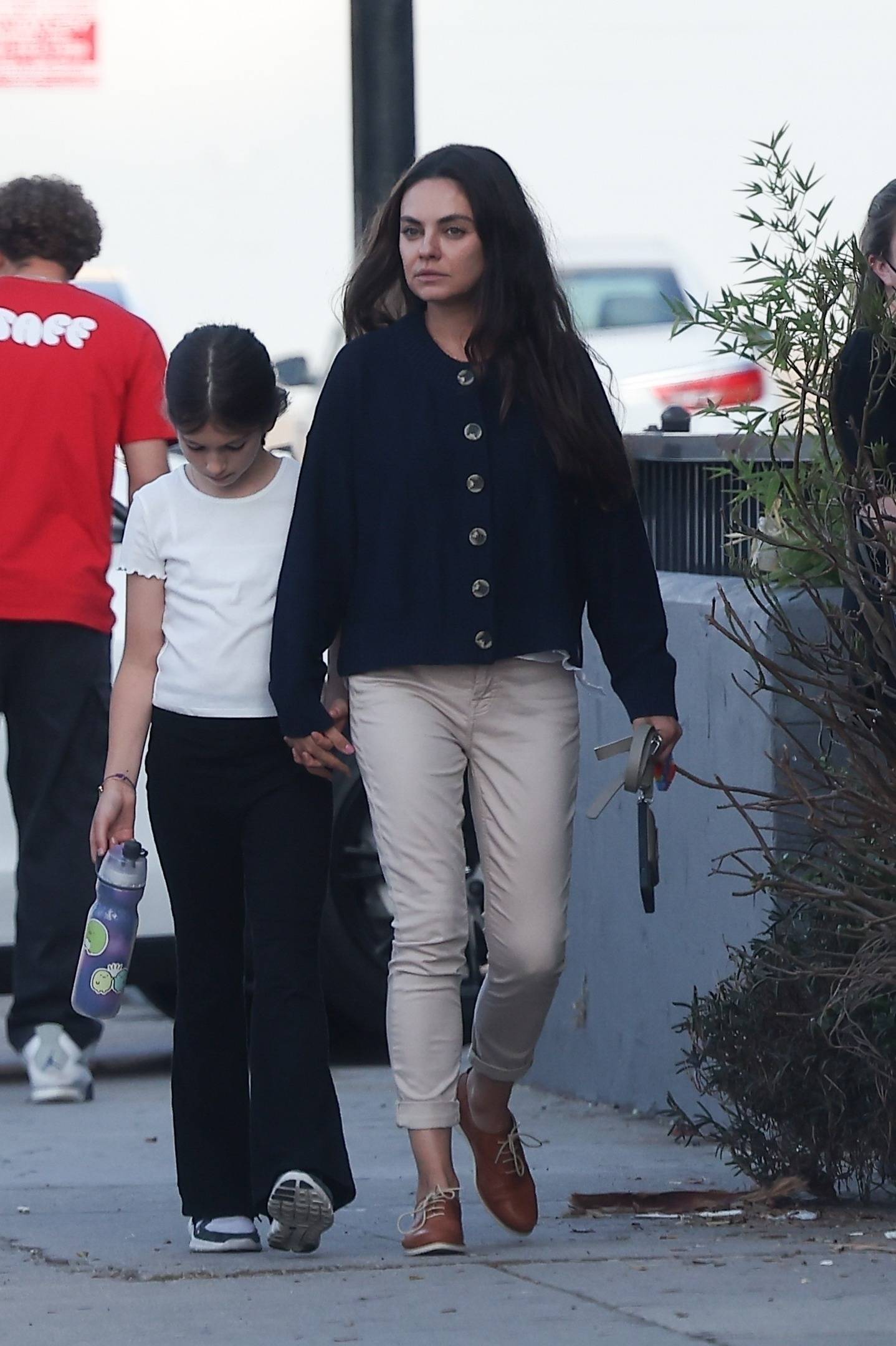 *EXCLUSIVE* Ashton Kutcher sports a mustache as he is seen taking his son to flag football, while Mila Kunis takes daughter to dance class in LA