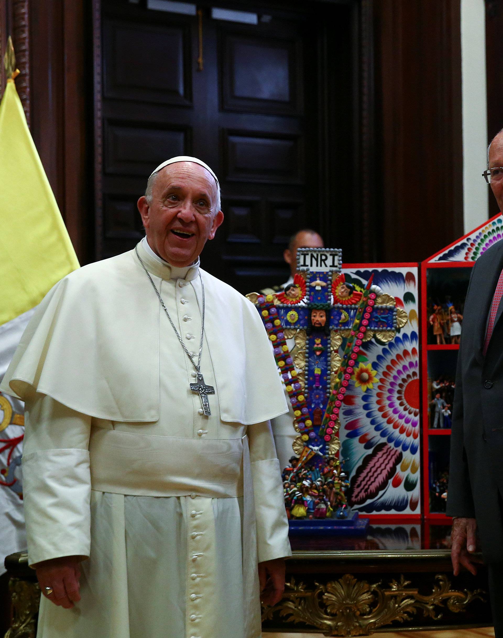 Peru's President Pedro Pablo Kuczynski gestures as he exchanges gifts with Pope Francis at the presidential palace in Lima