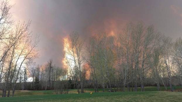 Wildfire is seen from MacDonald Island Park near Fort McMurray Alberta