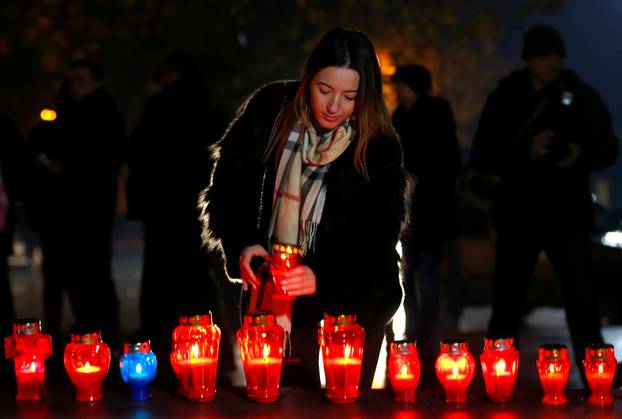 A Bosnian Croat woman lights a candle for the convicted general Slobodan Praljak, who killed himself seconds after the verdict in the U.N. war crimes tribunal in The Hague, in Mostar