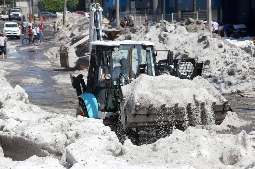 A truck carries ice as it cleans the street after a heavy storm of rain and hail which affected some areas of the city in ââGuadalajara,