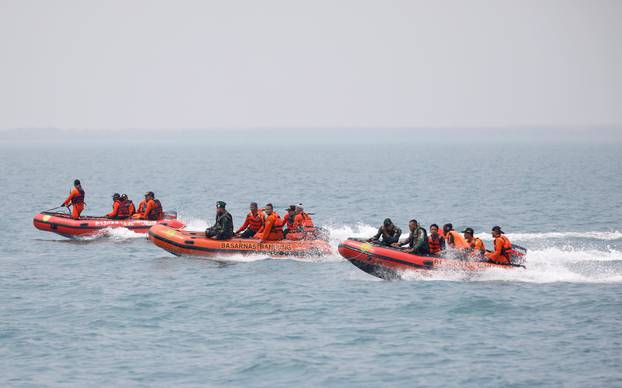 Rescue workers travel to a search area near Tanjung Pakis beach in Karawang, Indonesia