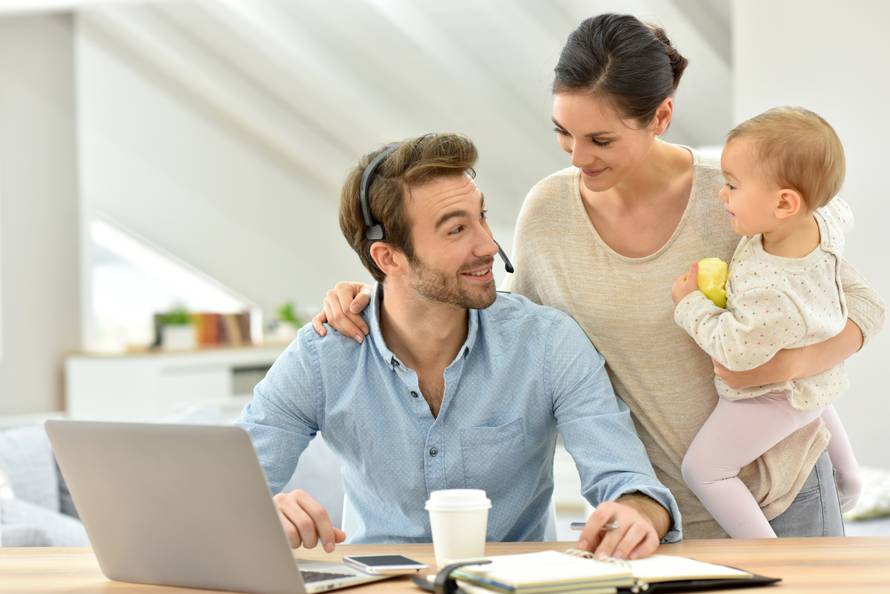 Man working from home, family around