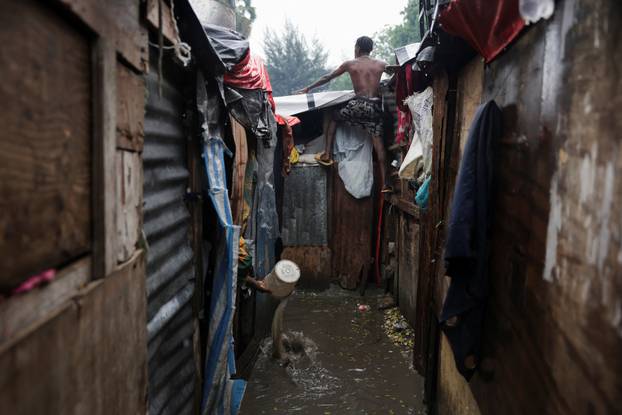 Haitians shelter from Hurricane Melissa's rains at church housing people displaced by gang violence, in Port-au-Prince