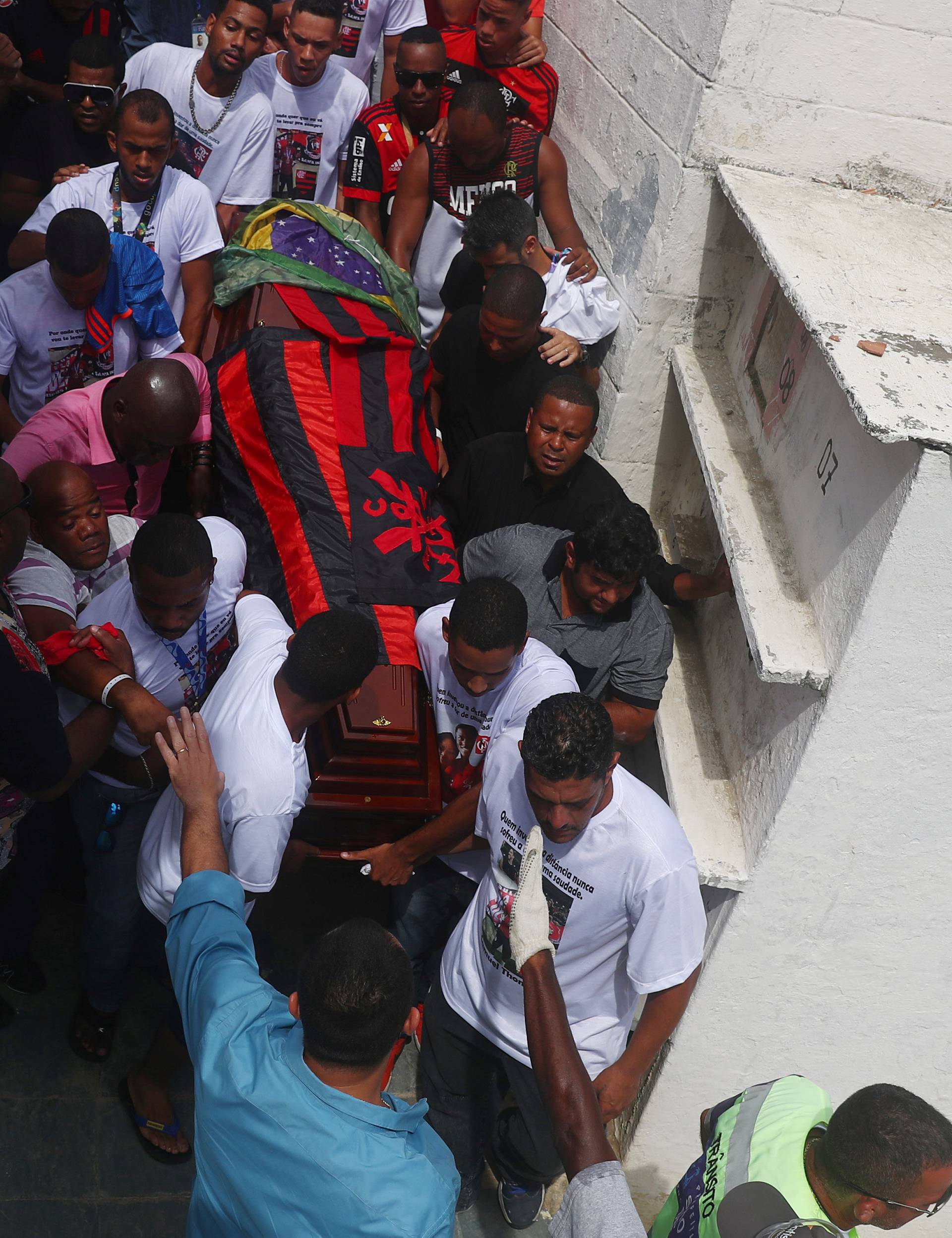 Relatives and friends of teenage soccer player Samuel Thomas de Souza Rosa, who died in the fire that swept through Flamengo's training ground react during his burial, in Rio de Janeiro