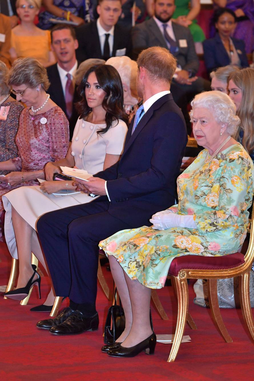 Britain's Queen Elizabeth, Prince Harry and Meghan, the Duchess of Sussex attend reception following the final Queen's Young Leaders Awards Ceremony at Buckingham Palace in London