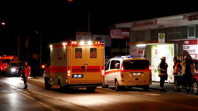 German emergency services workers work in the area where a man with an axe attacked passengers on a train near Wuerzburg