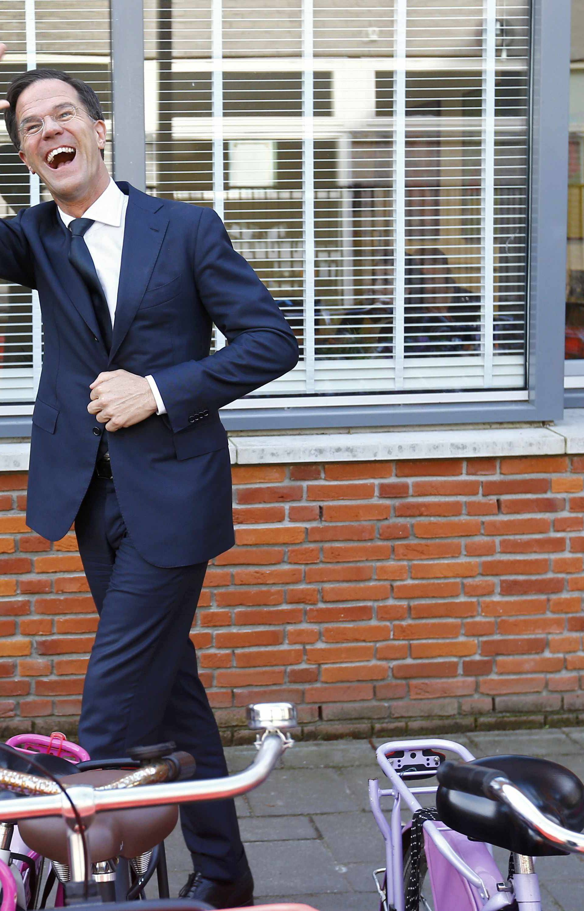 Dutch Prime Minister Mark Rutte of the VVD party waves after voting in the general election in The Hague