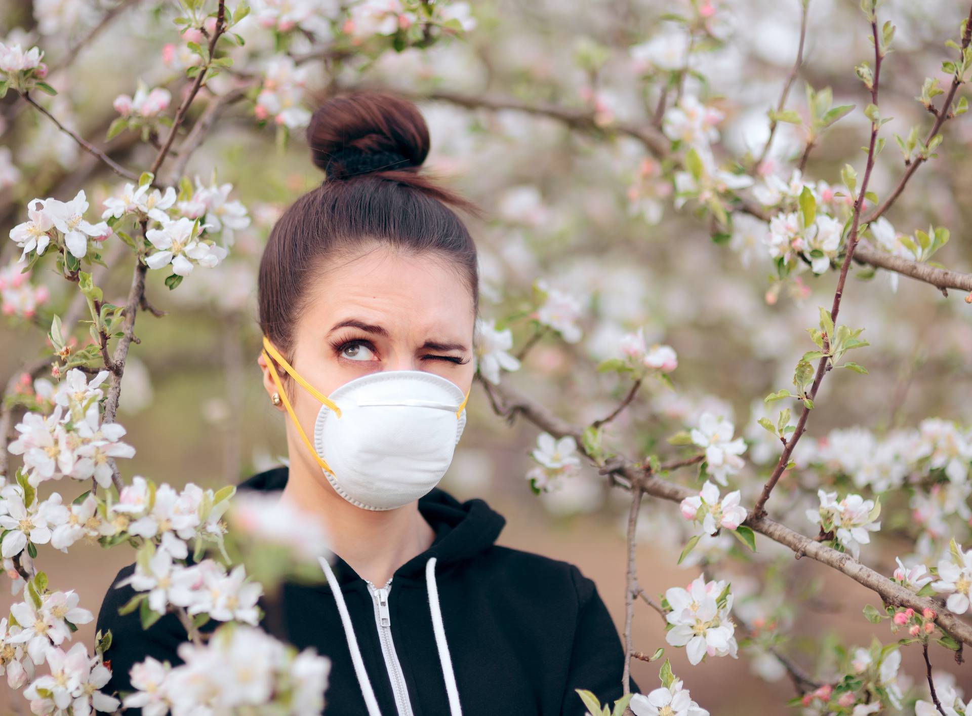 Woman with Respirator Mask Fighting Spring Allergies