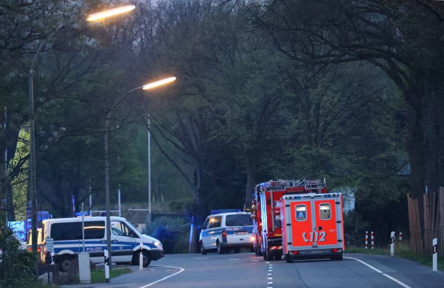 Police and emergency vehicles are seen near the Borussia Dortmund team hotel after an explosion before the game