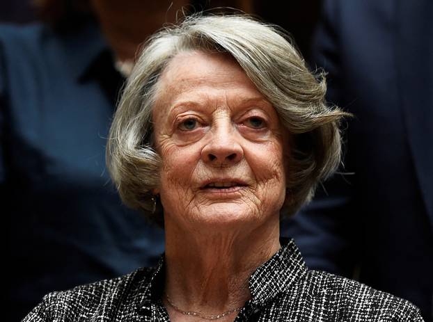 FILE PHOTO: Downton Abbey cast member Maggie Smith poses for the media at a hotel in London