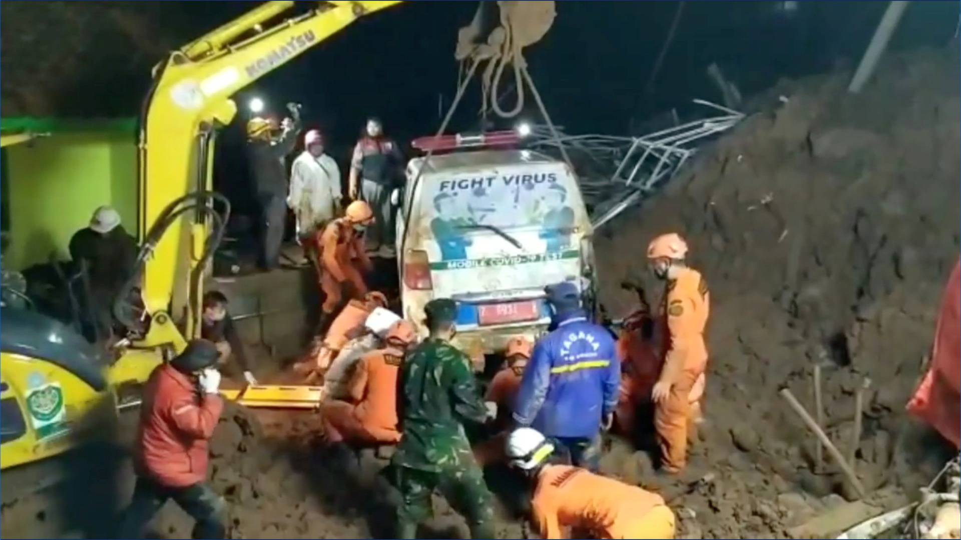 An ambulance is being lifted after it was buried in a landslide in Sumedang, West Java, Indonesia