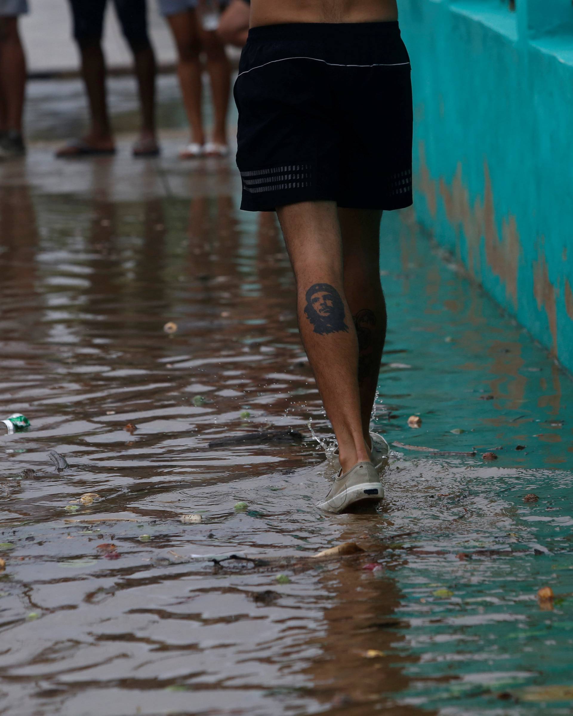 A man walks through a puddle as Hurricane Irma turns toward the Florida Keys on Saturday, in Havana