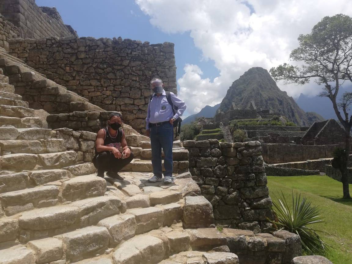 Japanese tourist Jesse Katayama poses for a photograph during his visit to the ruins of Machu Picchu