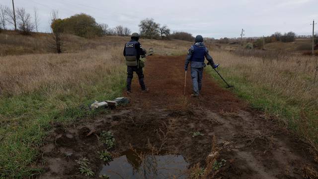 De-mining squad scan for unexploded ordnance and land mines, in Ruska Lozova
