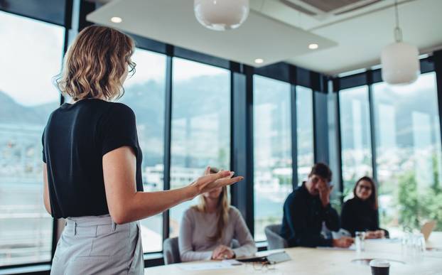 Businesswoman,Making,A,Presentation,To,Her,Colleagues,In,Office.,Female