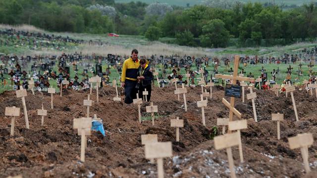A view shows newly-made graves at a cemetery outside Mariupol