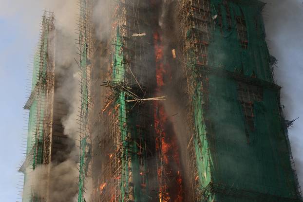 Flames engulf bamboo scaffolding across multiple buildings at Wang Fuk Court housing estate, in Tai Po