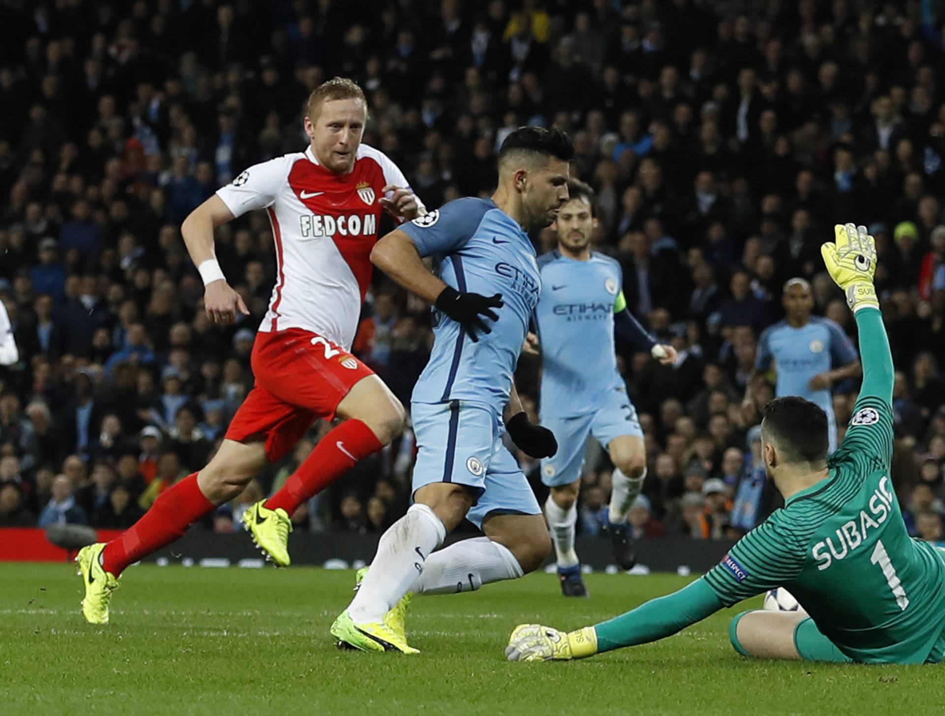 Manchester City's Sergio Aguero in action with Monaco's Danijel Subasic before being booked