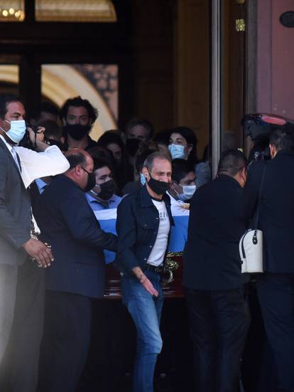 Pallbearers carry the casket of soccer legend Diego Maradona after a public viewing at the presidential palace Casa Rosada, in Buenos Aires