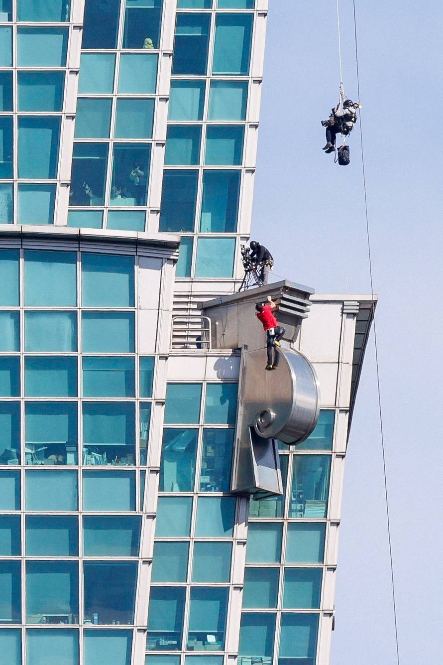 Climber Alex Honnold free soloing Taipei 101 Skyscraper in Taipei