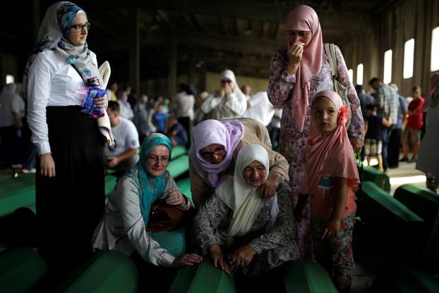 Muslim women cry near coffins of their relatives, who are newly identified victims of the 1995 Srebrenica massacre, which are lined up for a joint burial in Potocari near Srebrenica