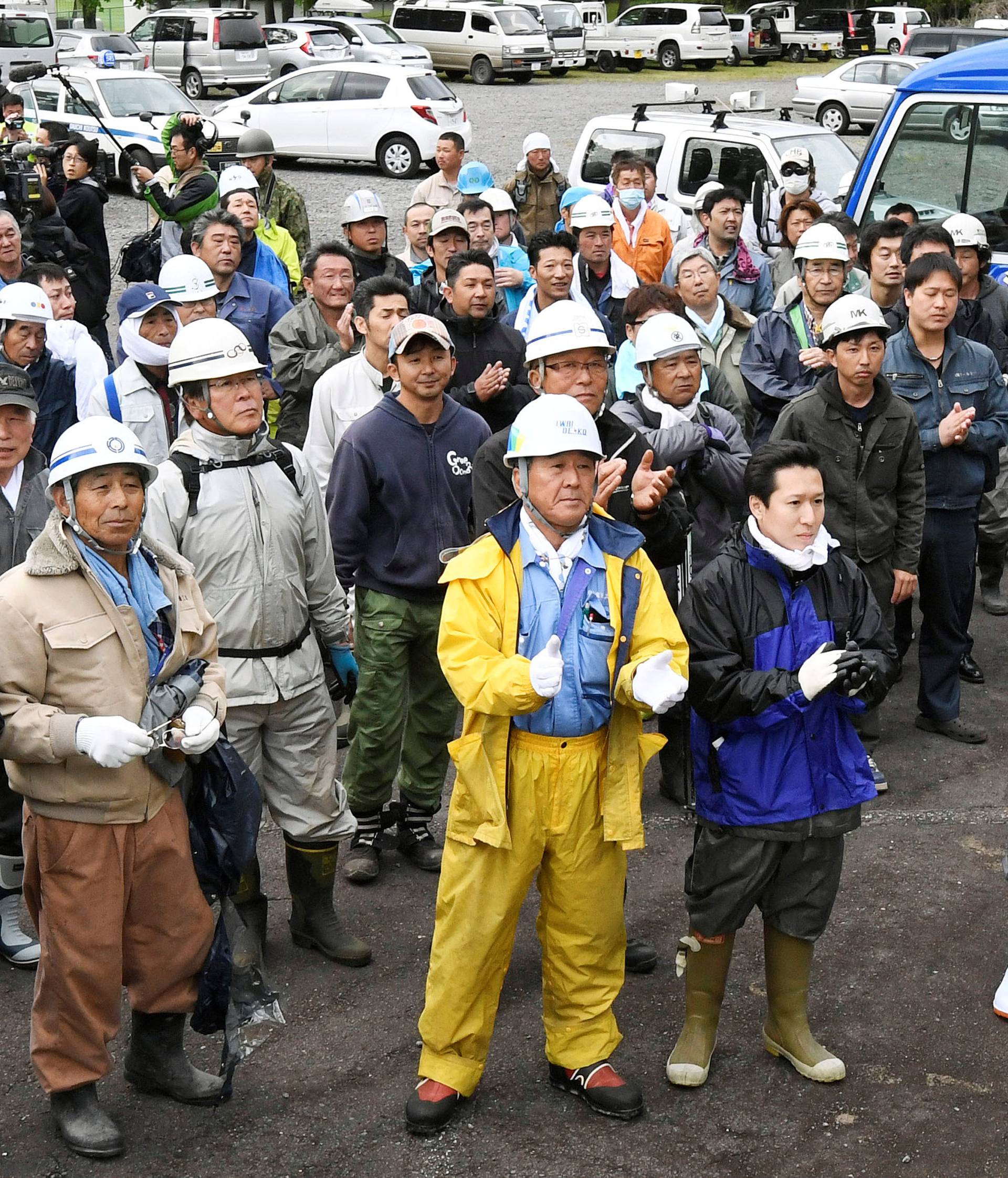 Members of search party for a 7-year-old boy who went missing on May 28, 2016 after being left behind by his parents, celebrate after the boy was found alive, in Nanae town on the northernmost Japanese main island of Hokkaido