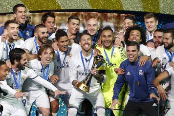 Real Madrid's Sergio Ramos and team mates celebrate winning the FIFA Club World Cup Final with the trophy